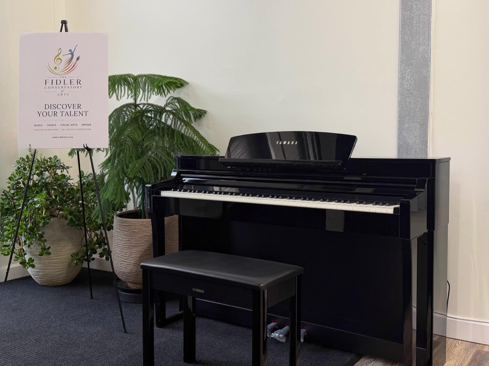 The Sparta studio, with a Yamaha piano and the conservatory's Discover Your Talent sign
